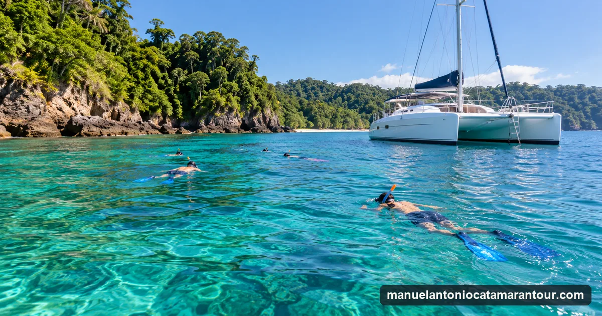 Snorkelers floating beside an anchored catamaran in a clear bay on Costa Rica's Pacific coast